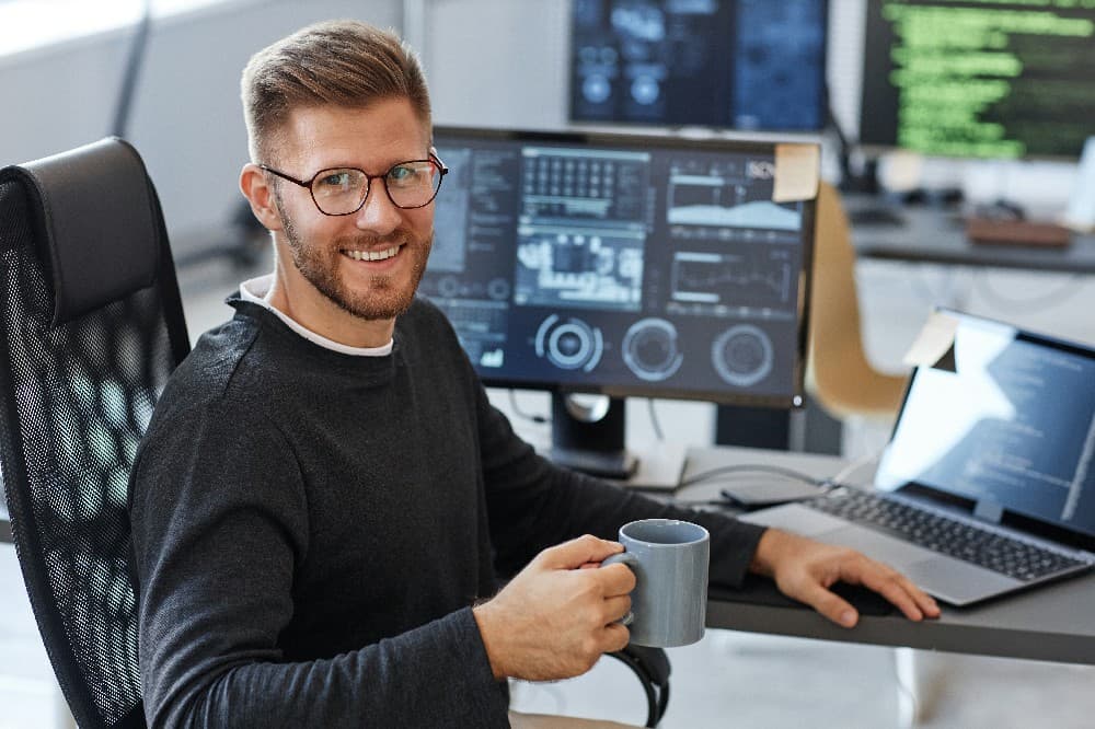 smiling-computer-programmer-at-workplace